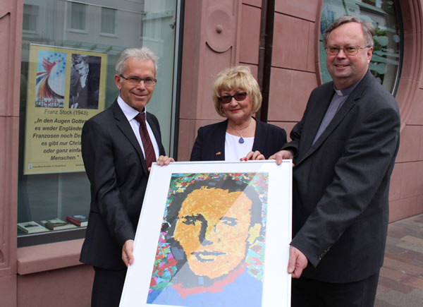 Foto: V.l.: Dr. Richard Böger, Vorstandsvorsitzender der Bank für Kirche und Caritas, Margarethe Dennemark, stellvertretende Vorsitzende des Franz-Stock-Komitees und Professor Dr. Rüdiger Althaus, Rektor der Theologischen Fakultät Paderborn, zeigen bei der Ausstellungseröffnung ein Mosaikbild von Franz Stock, das anlässlich eines Wettbewerbs von Schülern der Klasse 7 des Franz-Stock-Gymnasiums Arnsberg-Neheim gefertigt wurde.Foto: BKC